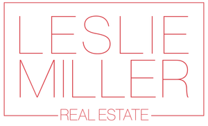 The logo for leslie miller real estate is red and white.