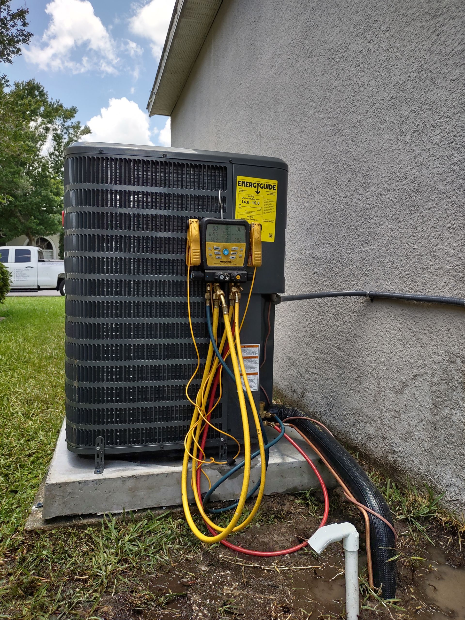 an air conditioner is being installed on the side of a house .