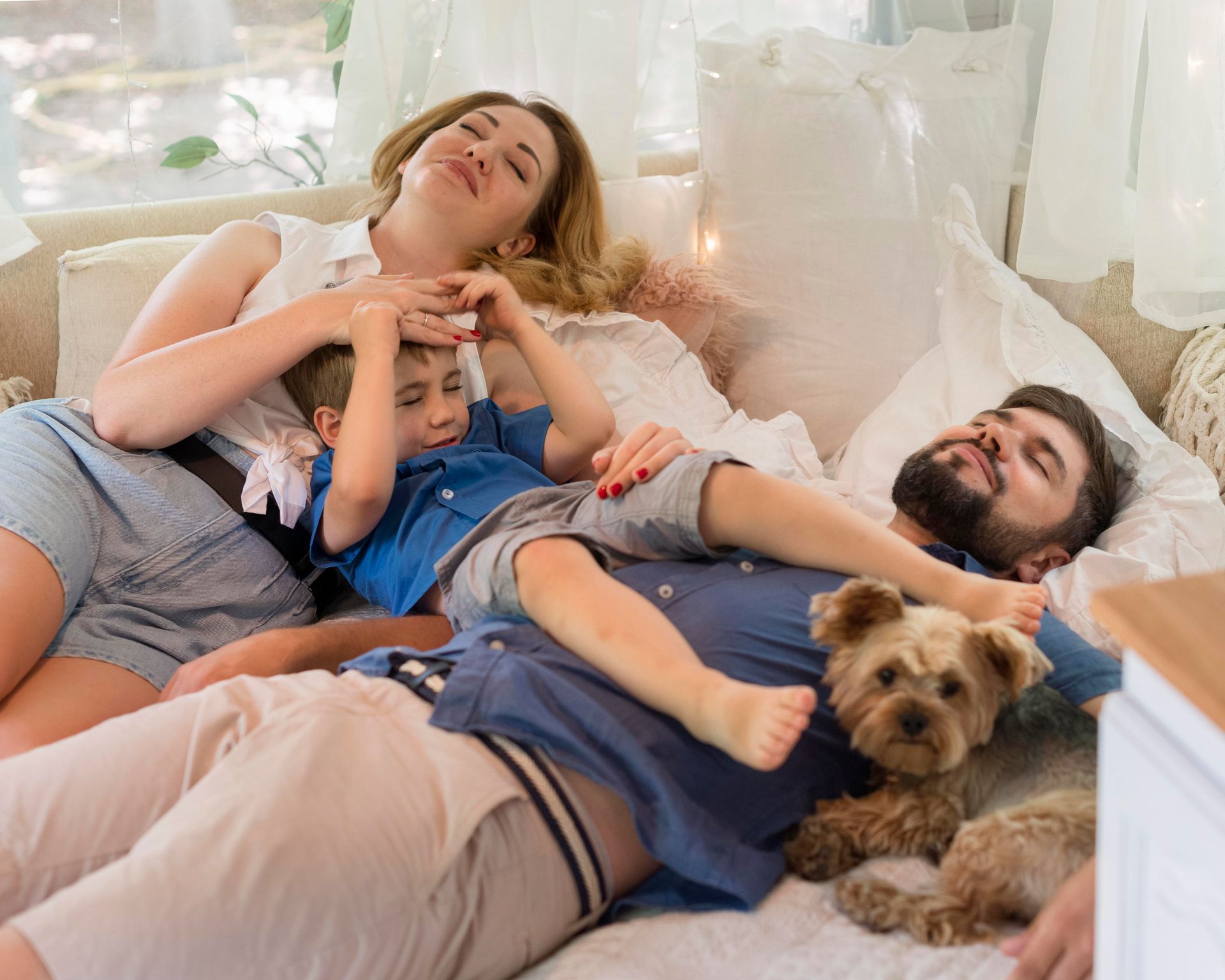 high angle family staying caravan bed with dog