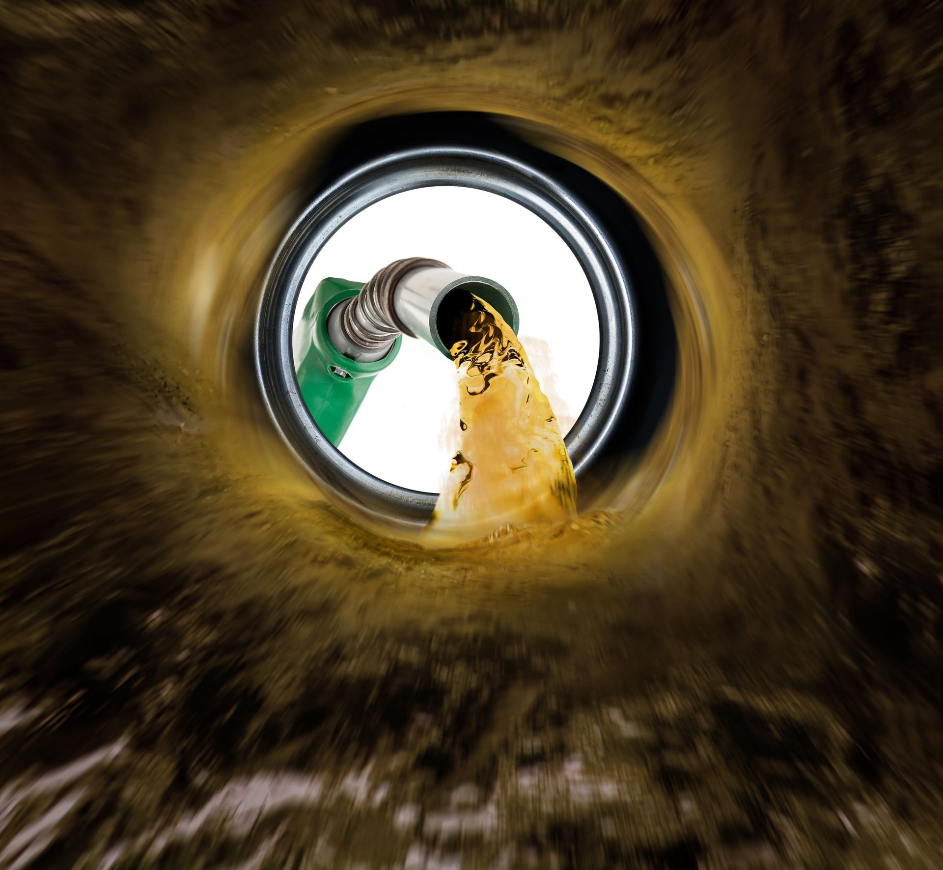 Looking up inside a drain pipe as muddy water pours from a green hose Looking up inside a drain pipe as muddy water pours from a green hose
