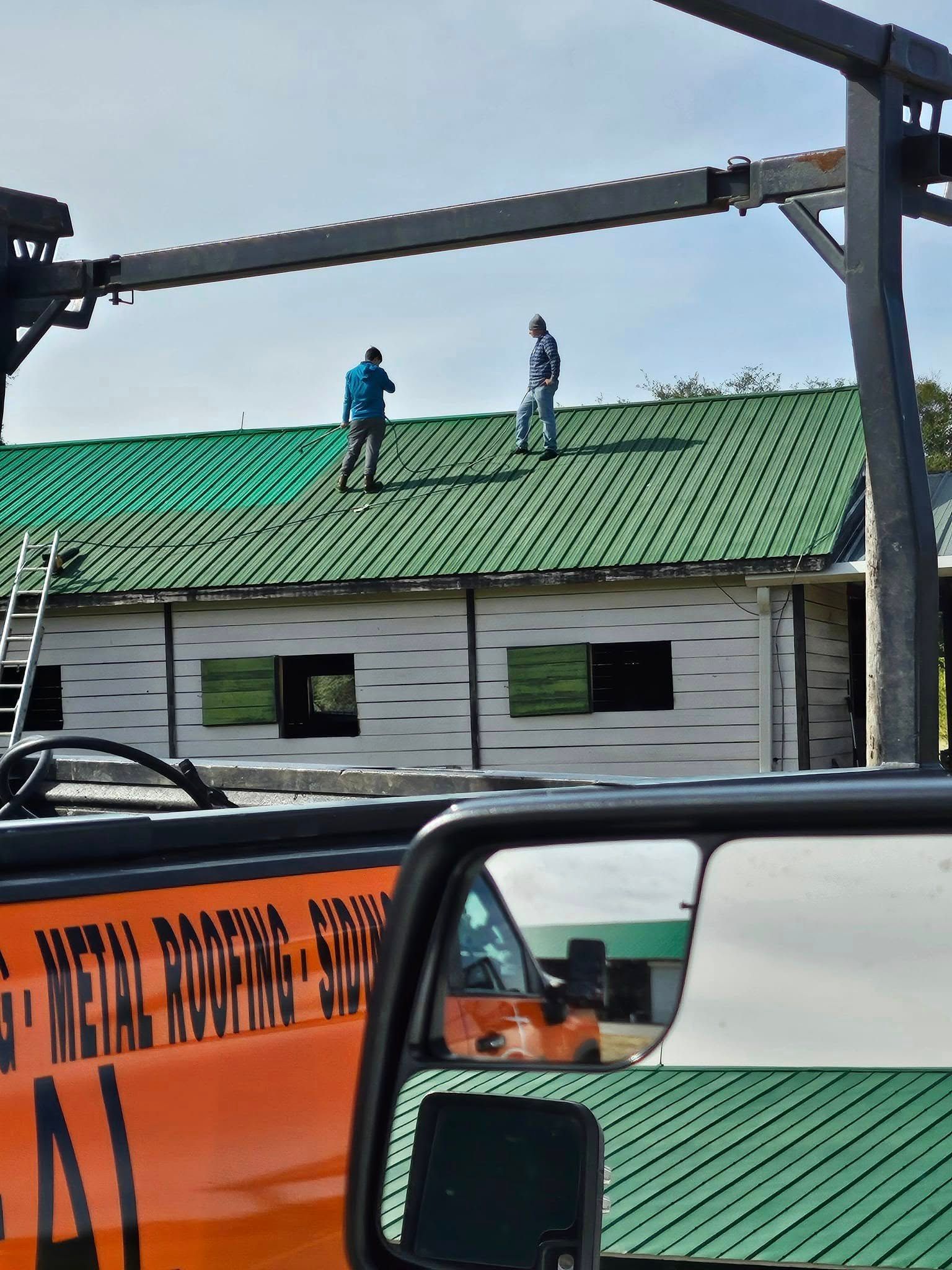 A man is working on the roof of a house.