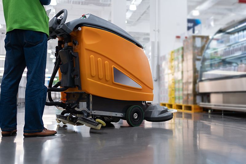 Cleaning The Floor Store With A Machine