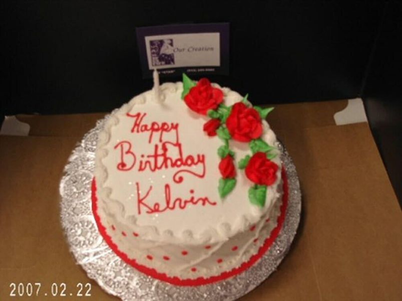 Birthday cake decorated with red roses and 
