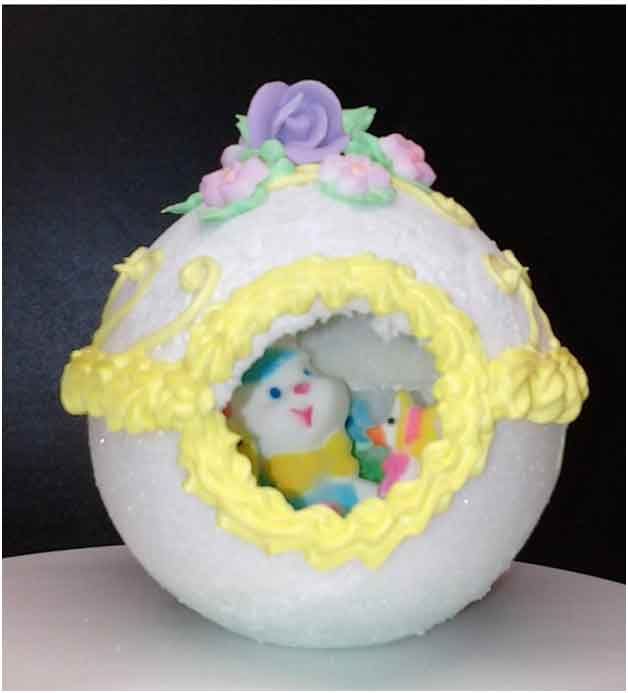 Easter egg cake with a bunny and pastel decorations.