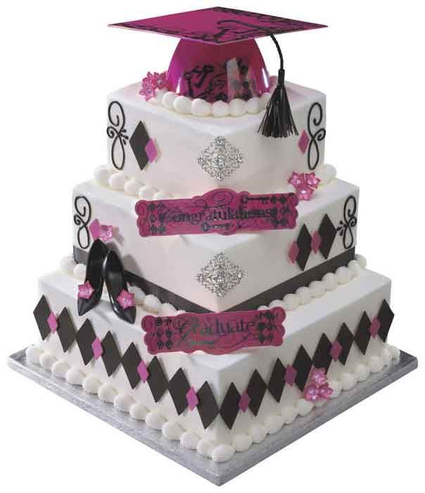 Three-tiered graduation cake with pink and black decorations; mortarboard topper, shoes.