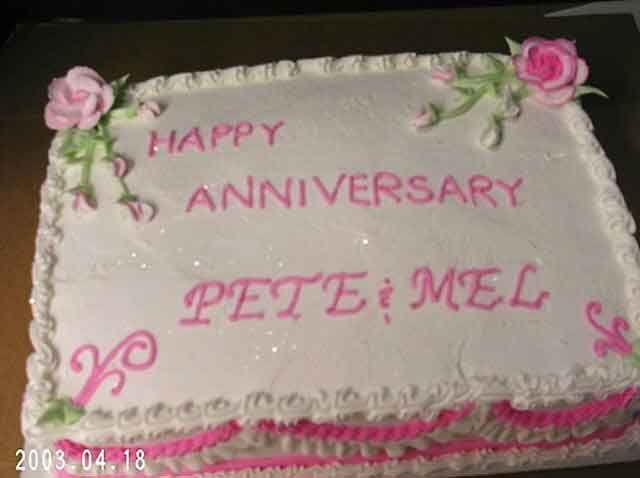 White cake with pink frosting that reads 