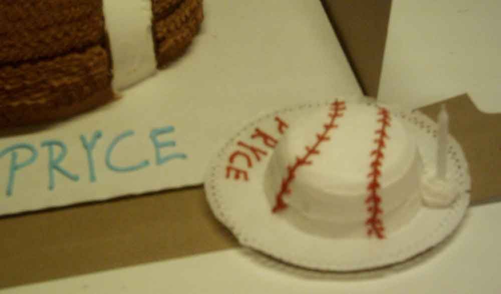 Baseball-themed cake with red stitching and 
