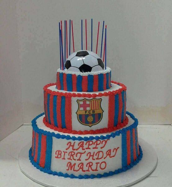 Three-tiered FC Barcelona birthday cake with soccer ball, team logo, and candles. 