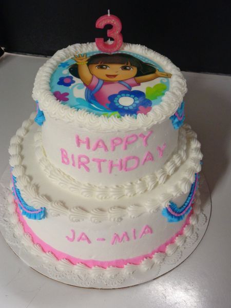 Two-tiered Dora the Explorer birthday cake with the number 3 candle.