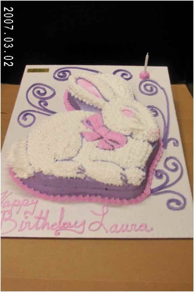 Rabbit-shaped birthday cake with pink and purple frosting, text 