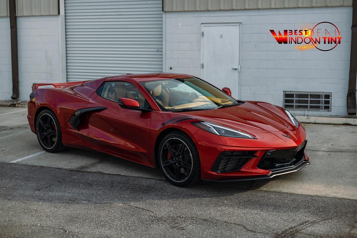 A red sports car is parked in front of a building.