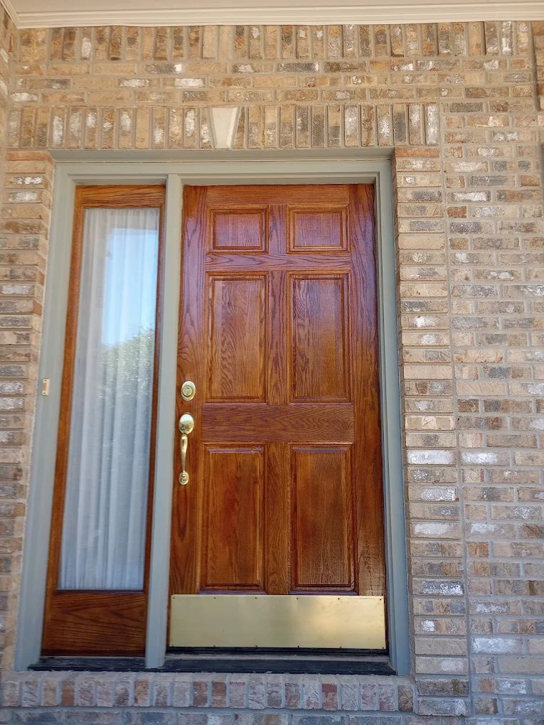 A brick building with a wooden door and a window