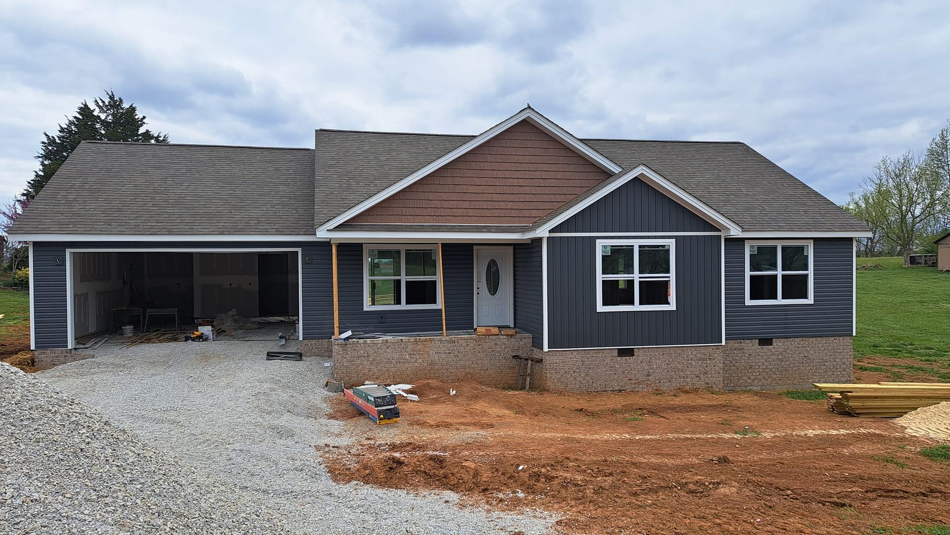 A house is being built in the middle of a dirt field