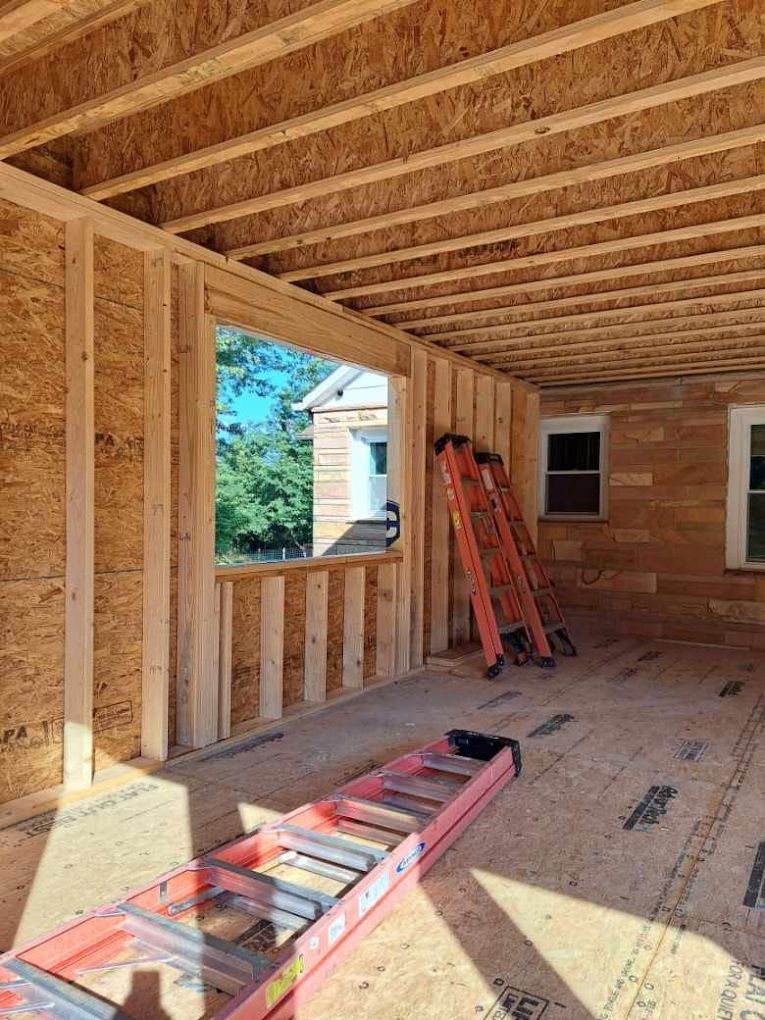 A ladder is sitting in the middle of a room under construction