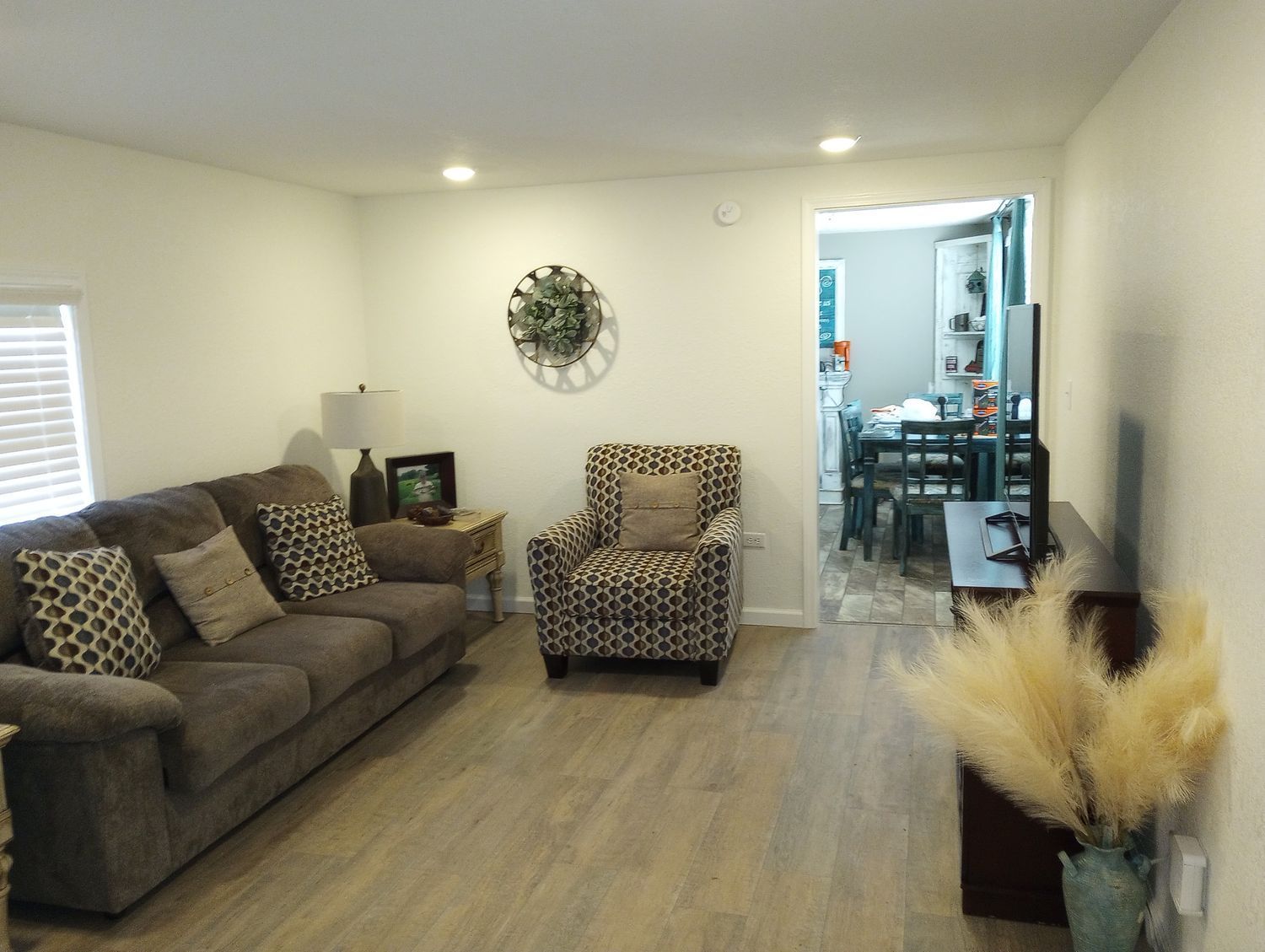 A living room with a couch , chair , and television