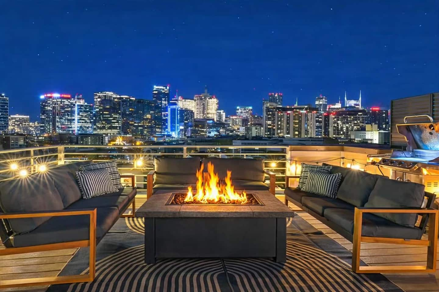 Rooftop patio with string lights and outdoor seating at a four-bedroom Nashville vacation rental man