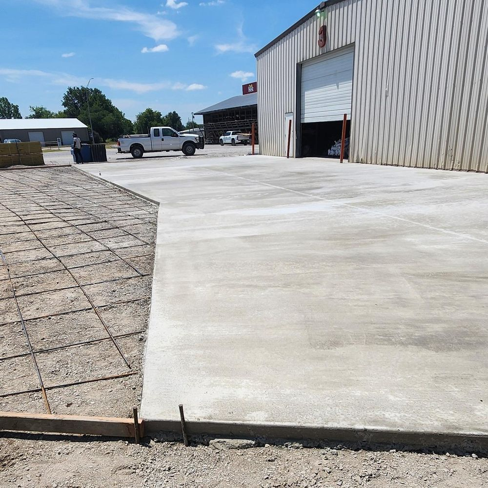 A concrete driveway is being built in front of a building