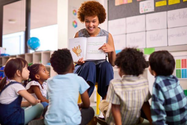 Teacher Holding a Children's Book - Skokie, IL - The Education Foundation