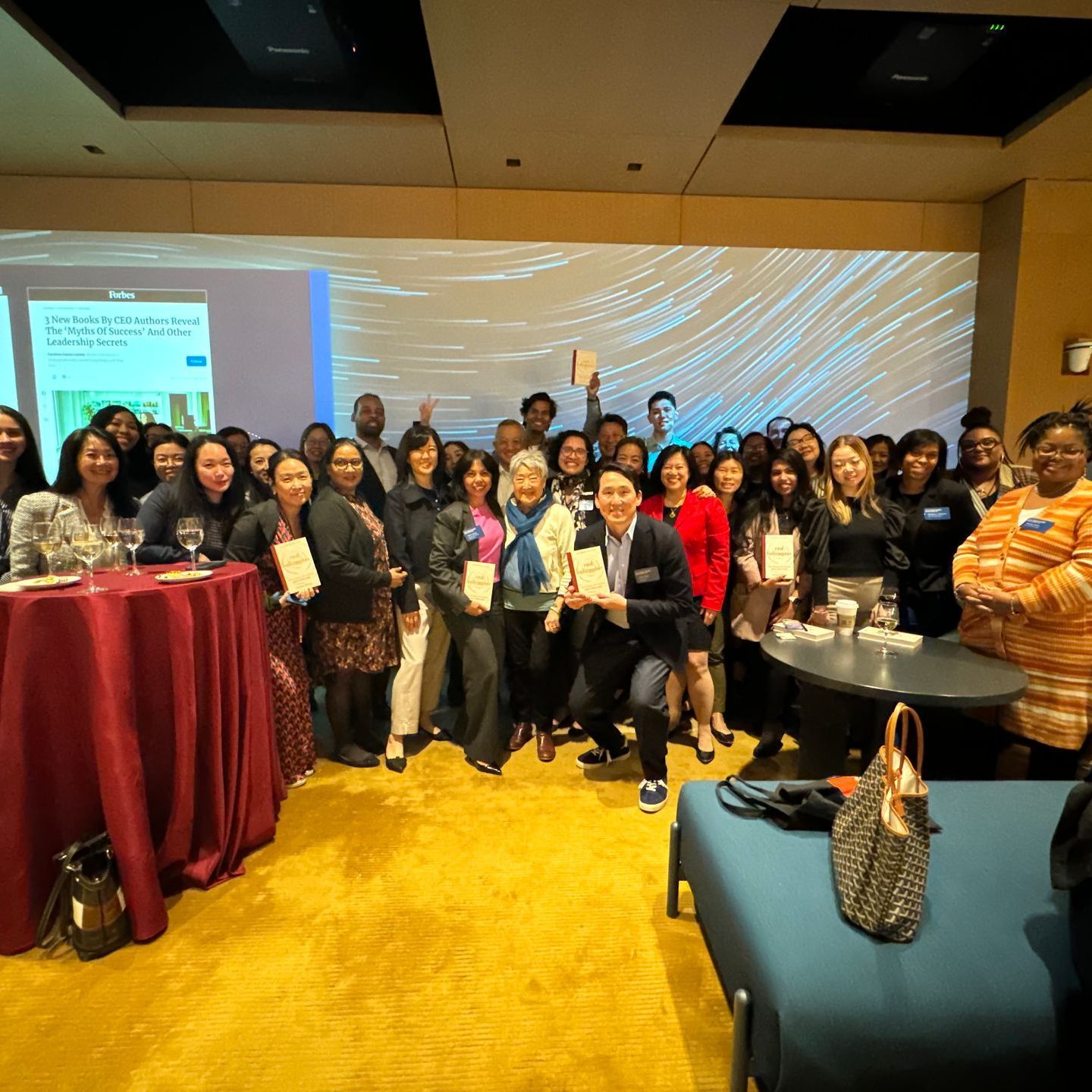 A large group of people are posing for a picture in a room