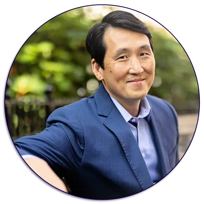 A man in a blue suit and tie is smiling in a circle.