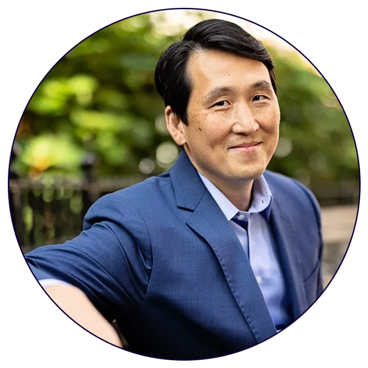 A man in a blue suit and tie is smiling in a circle.