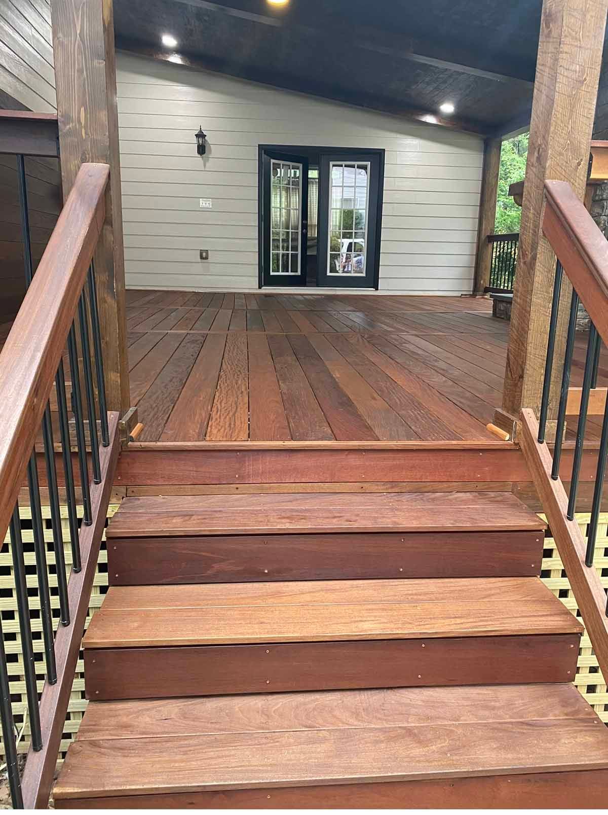 A wooden deck with stairs leading up to it