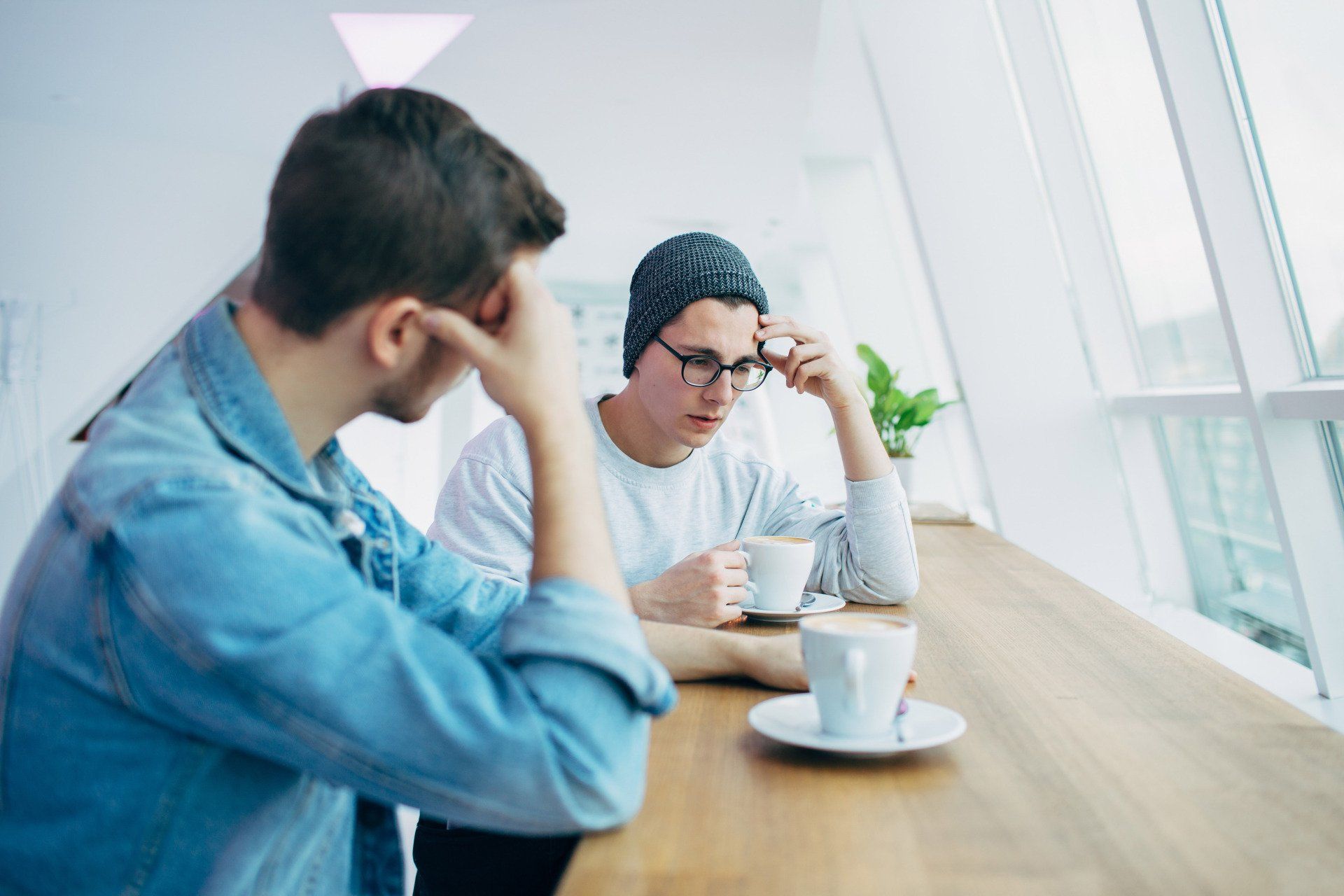 Two men having a conversation over a coffee