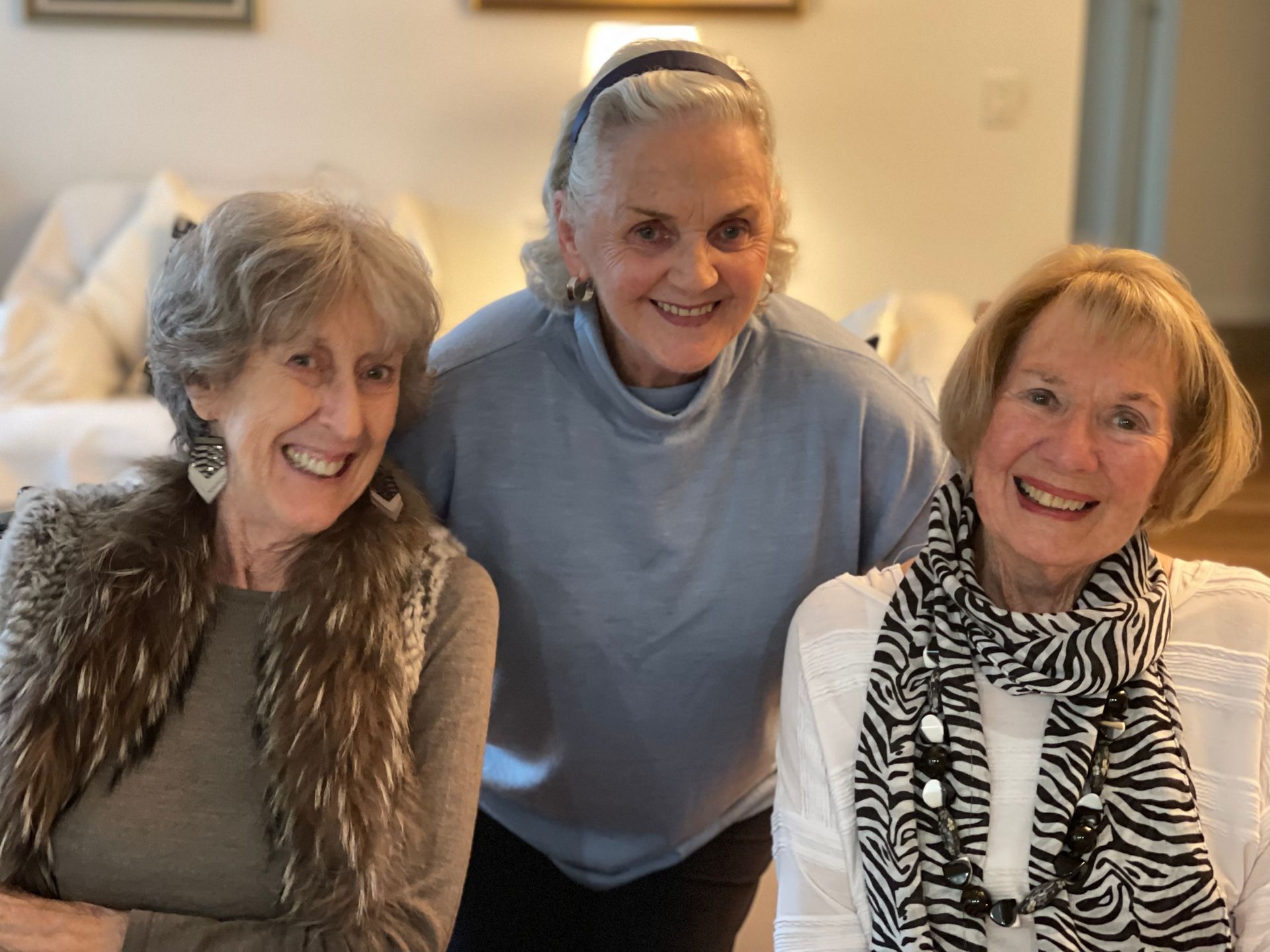 The three smiling Barbaras pose for a photo