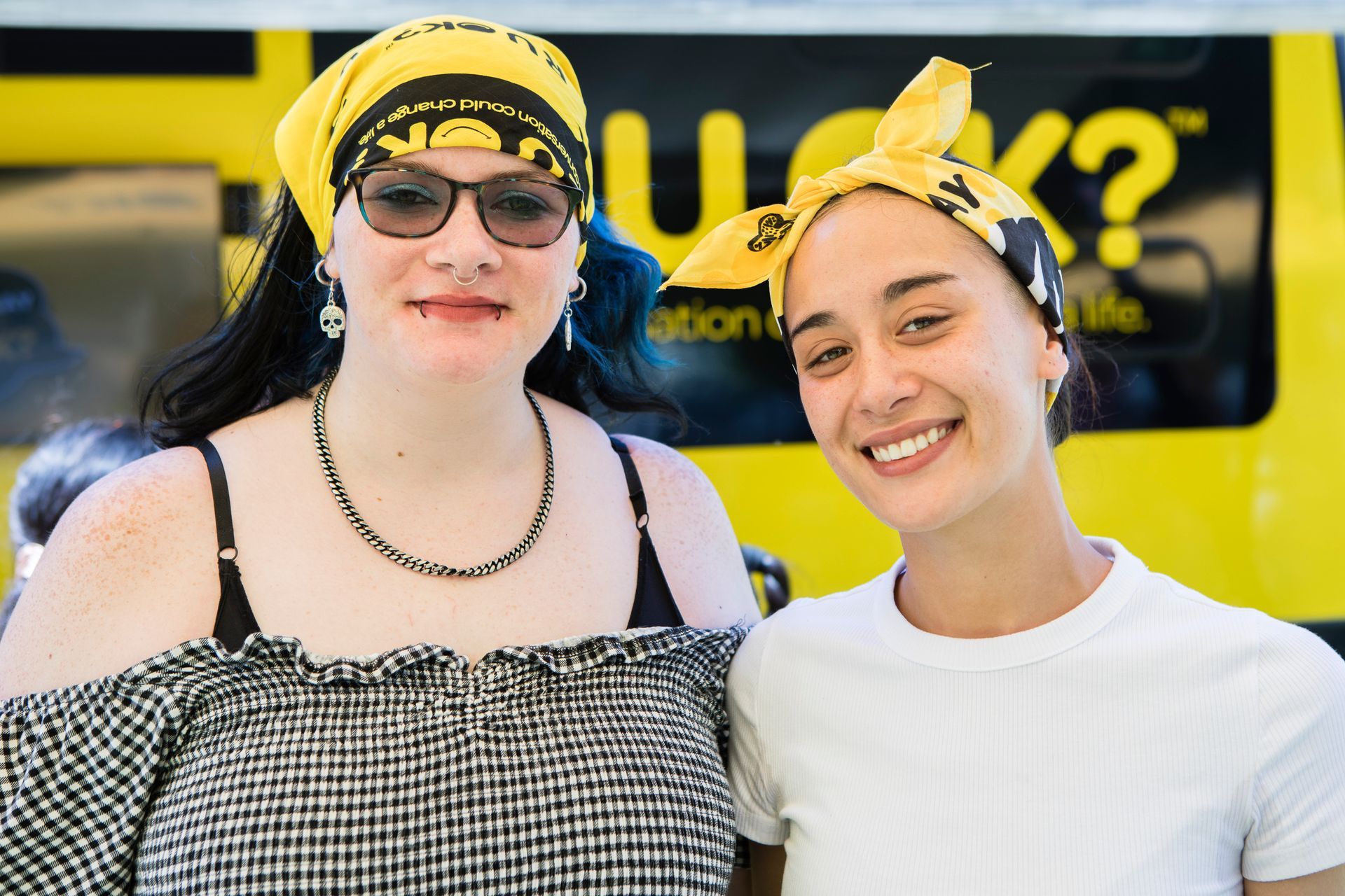 Group of women smiling with R U OK? Signs