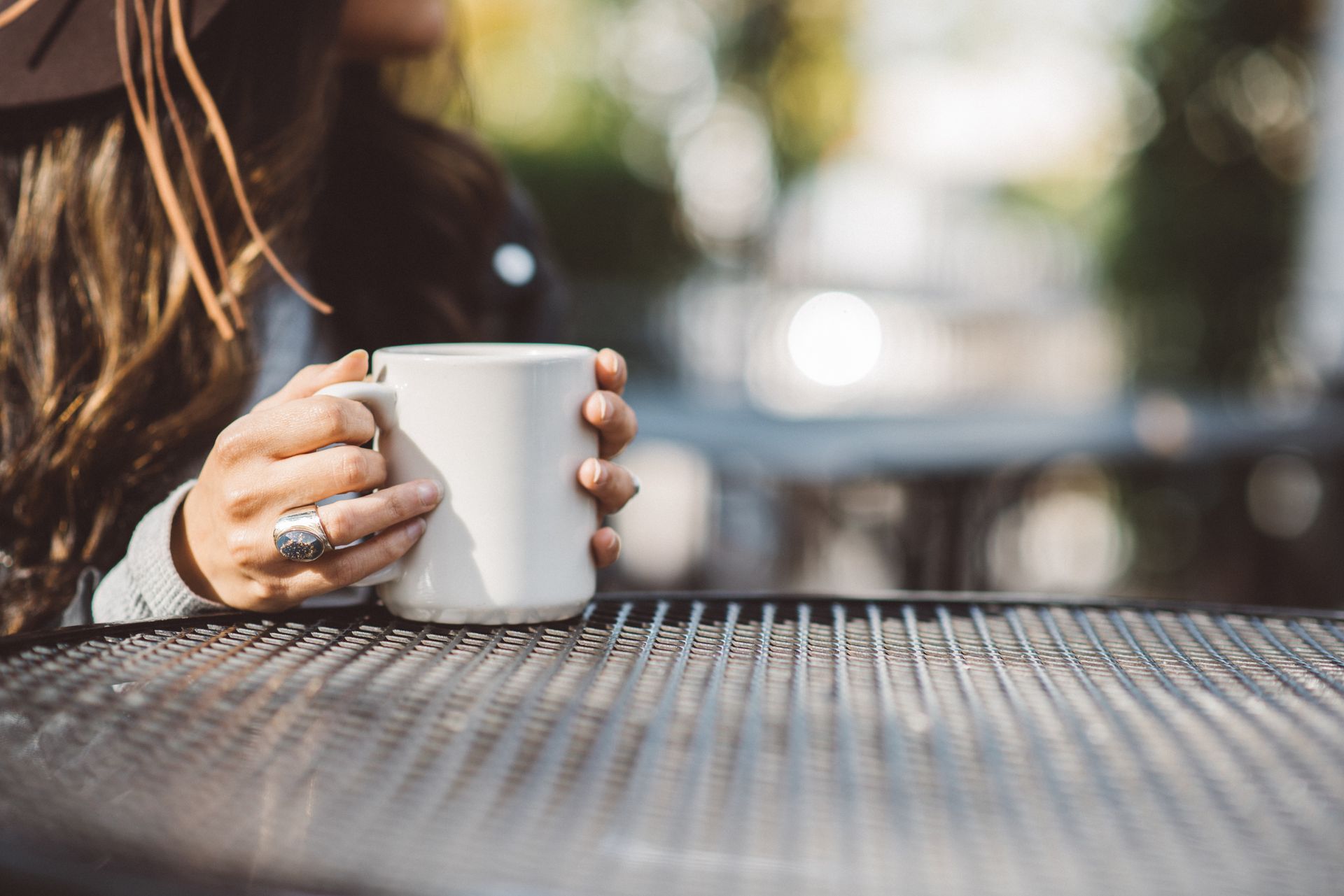 A pair of hands are holding a mug