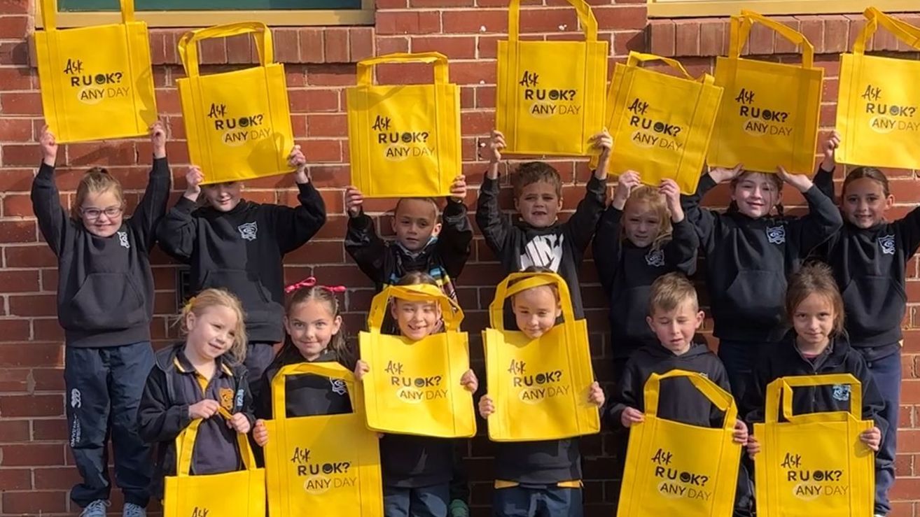 Students hold up R U OK? bags