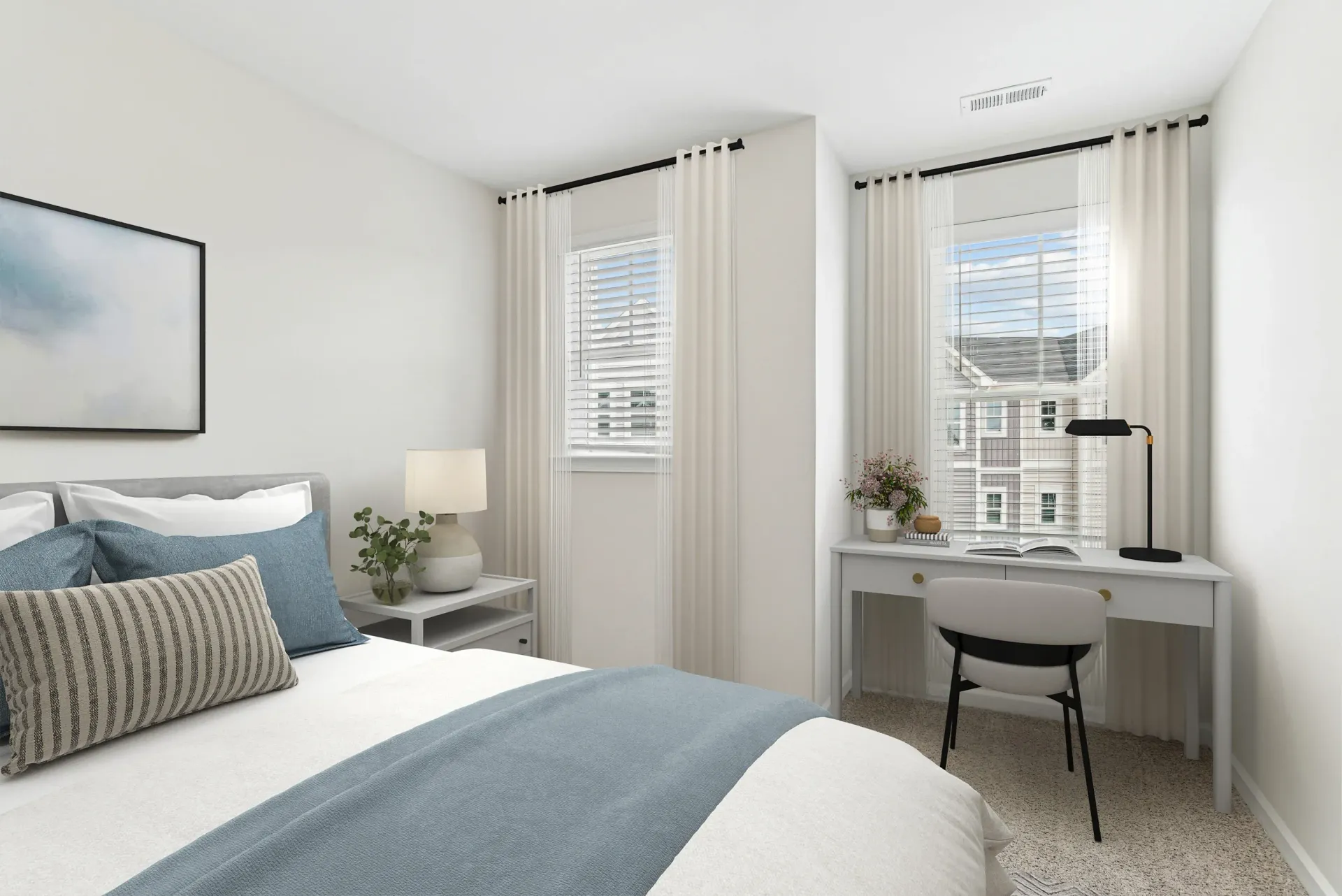 Bright modern bedroom with bed, desk, and two windows with sheer curtains.