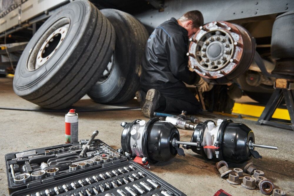 A Man Is Working On A Truck In A Garage — All Engine Repairs in South Murwillumbah, NSW