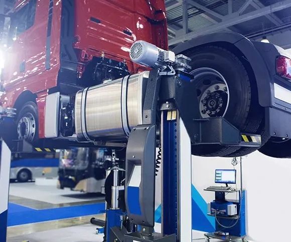 A Red Truck Is Sitting On Top Of A Lift In A Garage — All Engine Repairs in South Murwillumbah, NSW