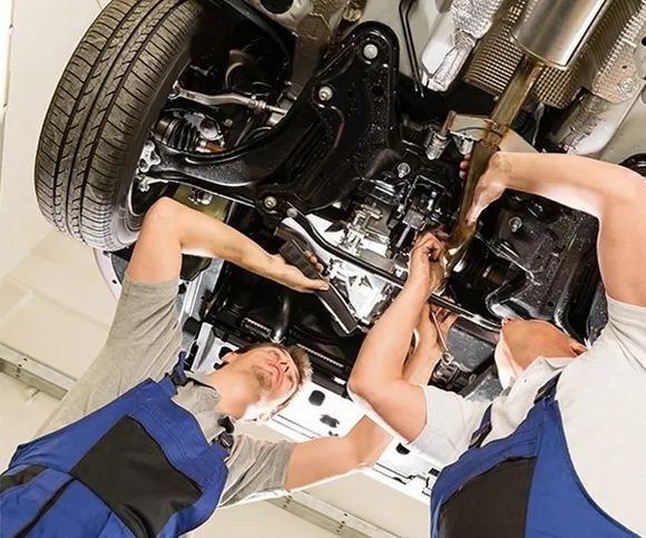 Two Men Are Working On The Underside Of A Car — All Engine Repairs in South Murwillumbah, NSW