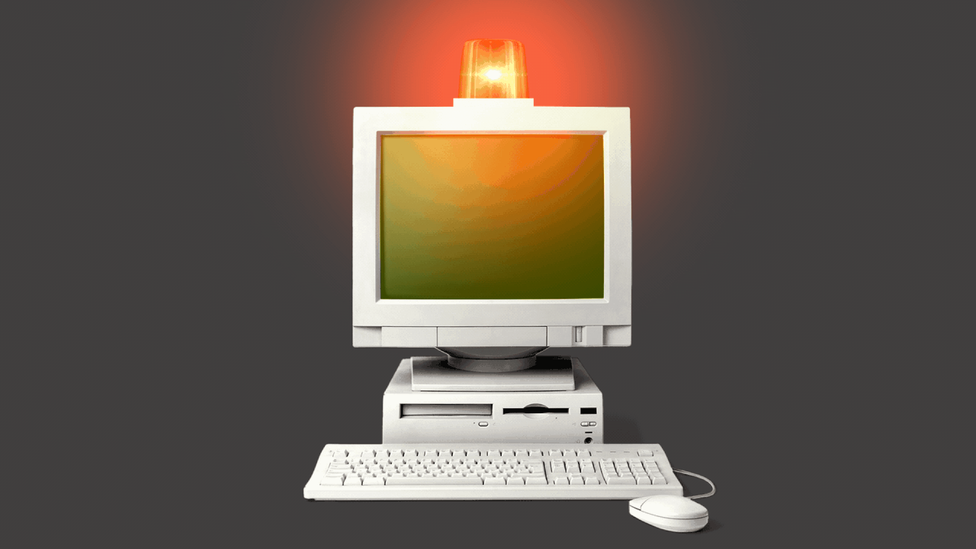 A computer with a warning light on top of it