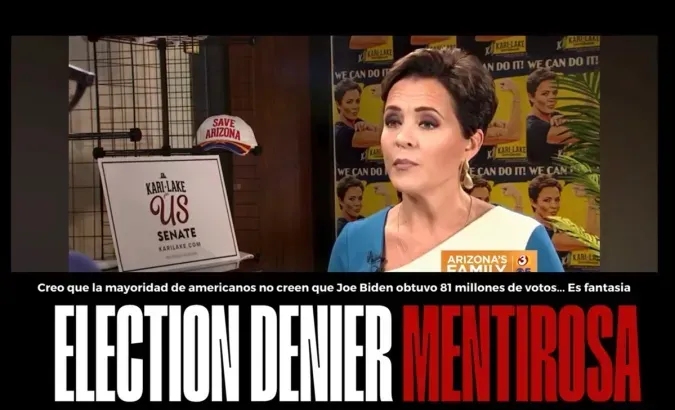A woman is standing in front of a sign that says election denier mentirasa