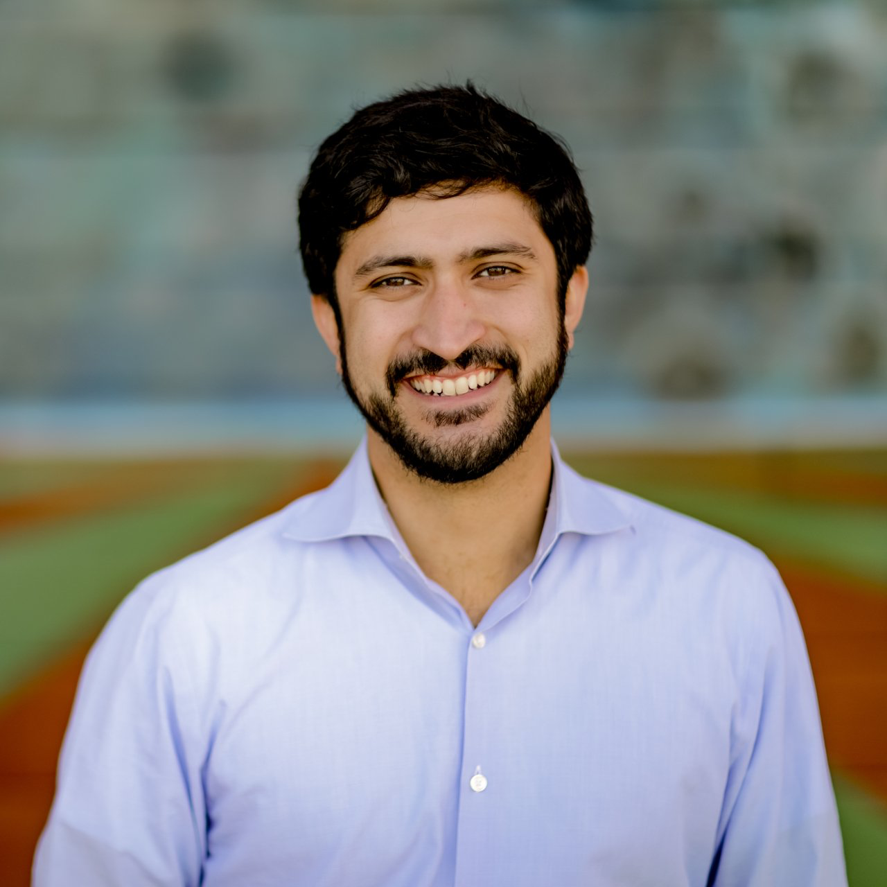 A man with a beard is smiling for the camera