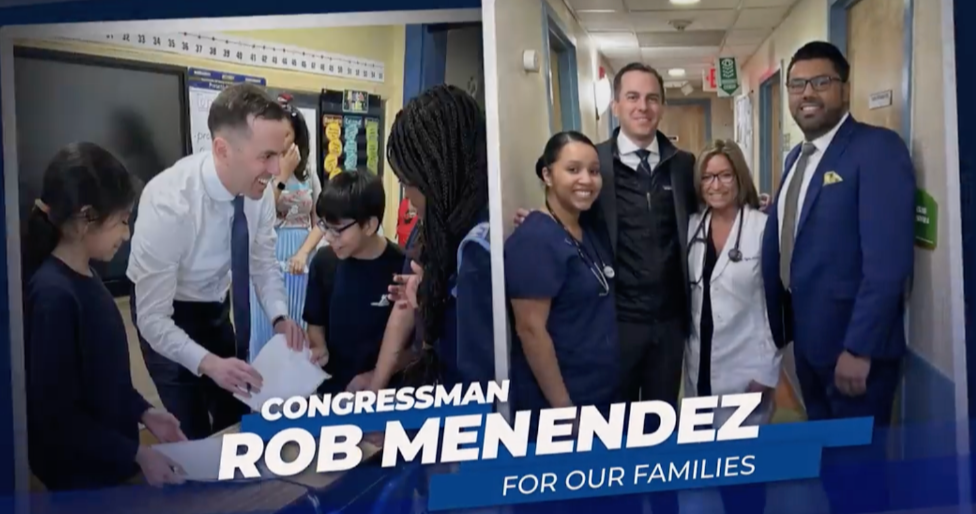 A group of people standing next to each other in a hallway.