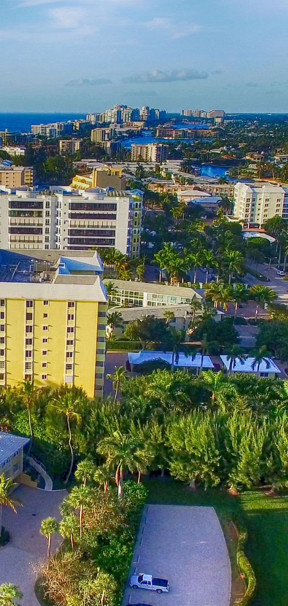 A large house with a large swimming pool in front of it.