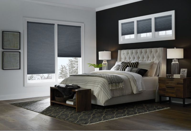 A bedroom with a bed , nightstand , and window shades. Love is Blinds Arizona (844) 936-2446