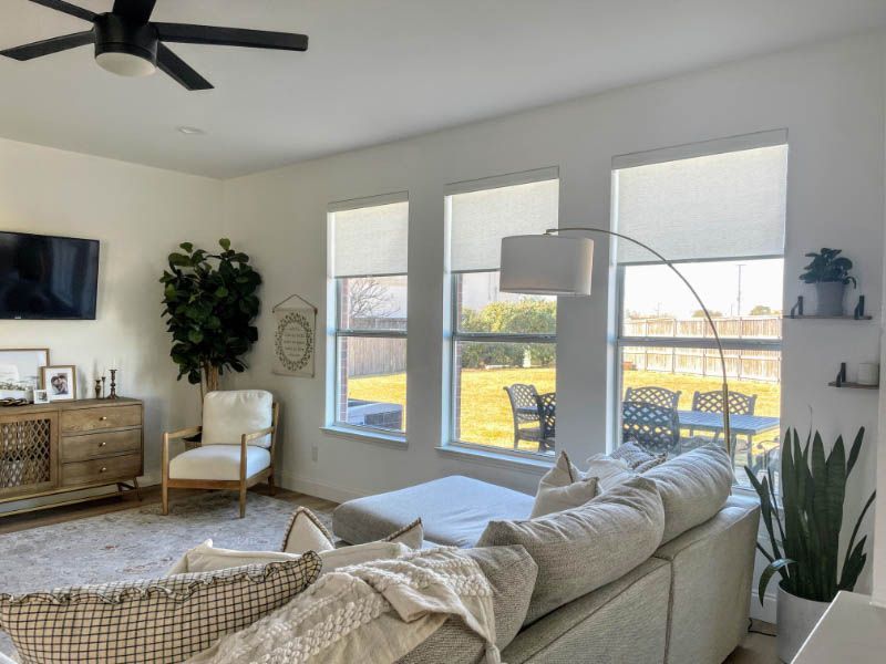 A living room with a couch , chair , television and ceiling fan. Love is Blinds Arizona (844) 936-2446