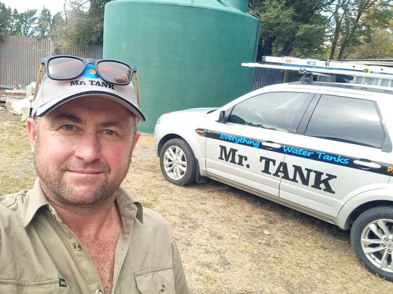 Mr Tank standing beside his work truck Mr Tank standing beside his work truck