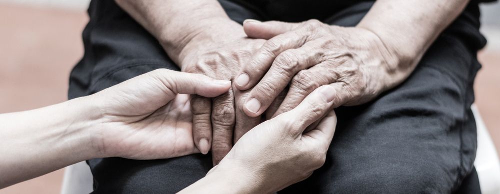 A Woman Is Holding The Hands Of An Older Woman — NQ Health In Bayview Heights, QLD