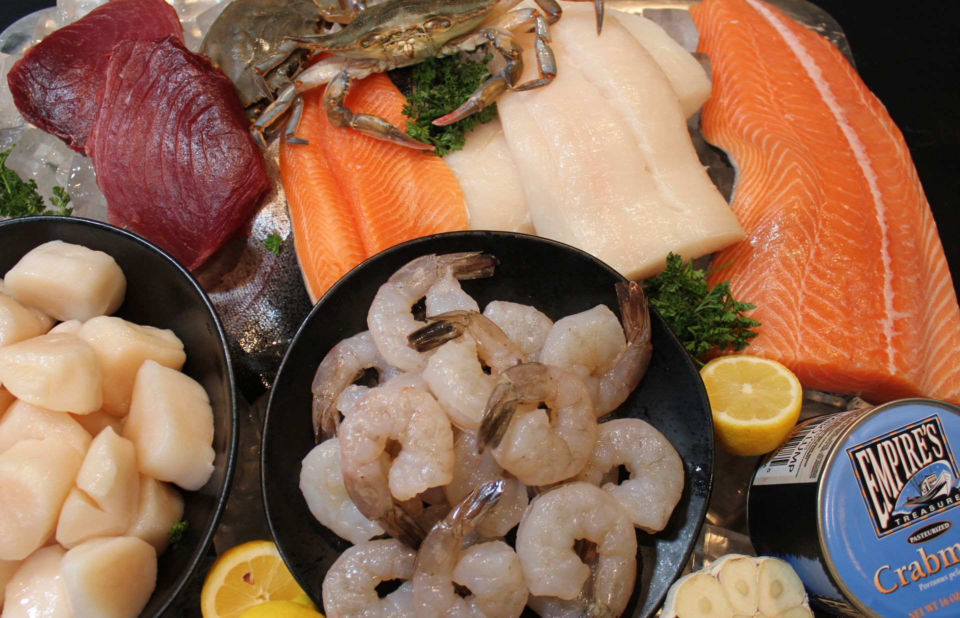 A variety of seafood including shrimp and salmon