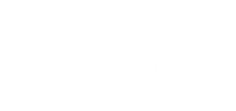 A white logo for a restaurant called truffles restaurant.