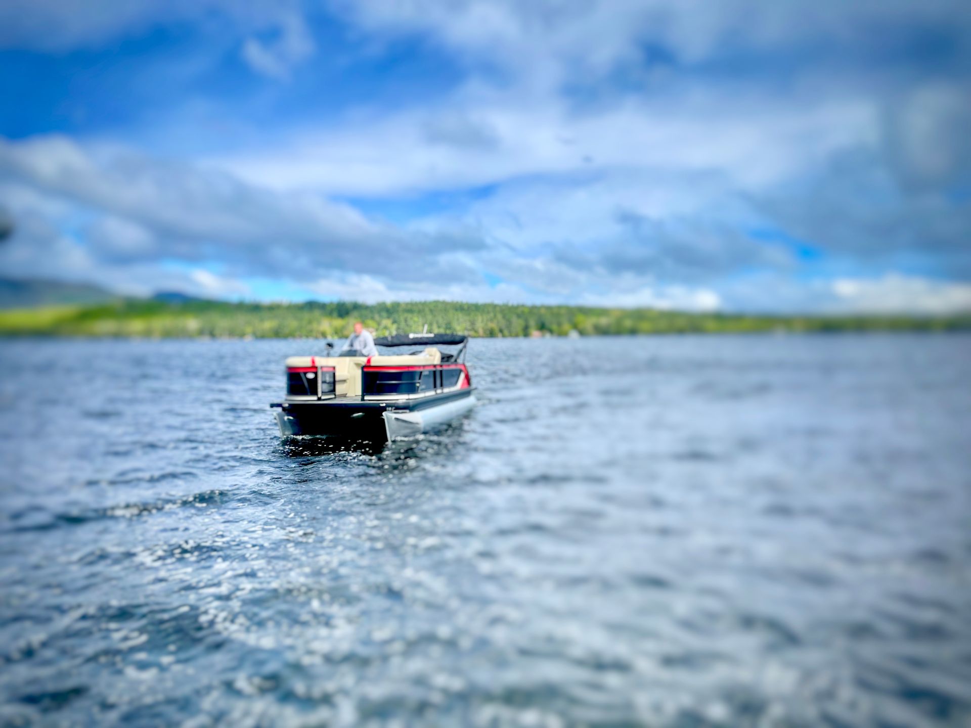 Pontoon boat cruising on an Adirondack lake