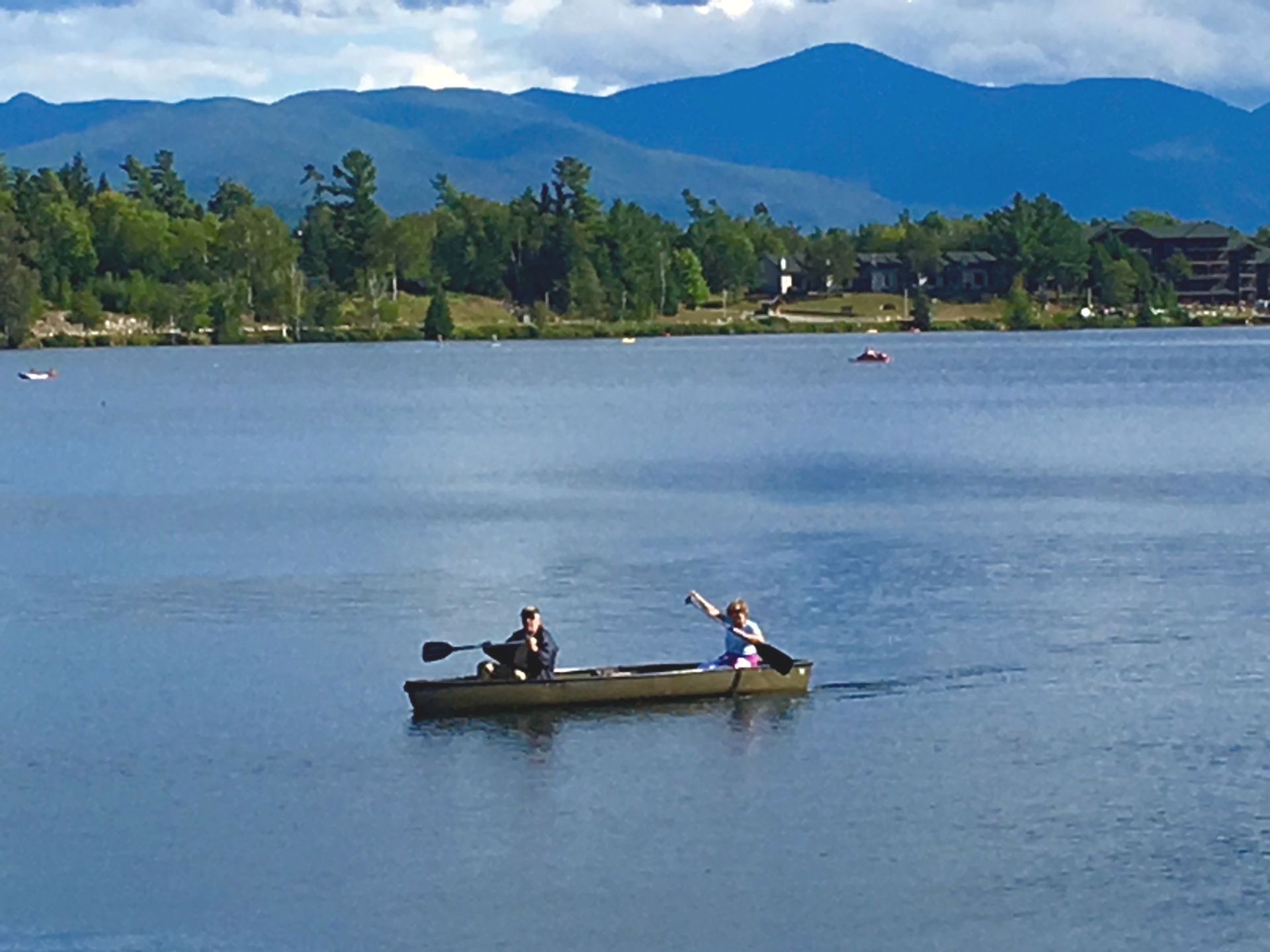 People paddling in a canoe on Mirror Lake in Lake Placid, NY