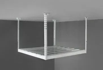 a white metal shelf is hanging from the ceiling in a garage .