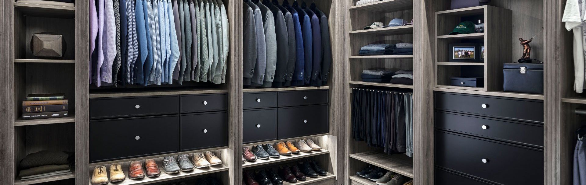 A walk in closet filled with lots of clothes and shoes.